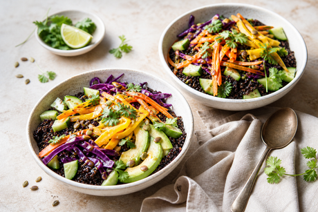 Black quinoa bowls with mango, colourful vegetables and pumpkin seeds