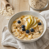 Creamy Organic Brown Rice Flakes porridge with pear, blueberries, seeds and maple drizzle