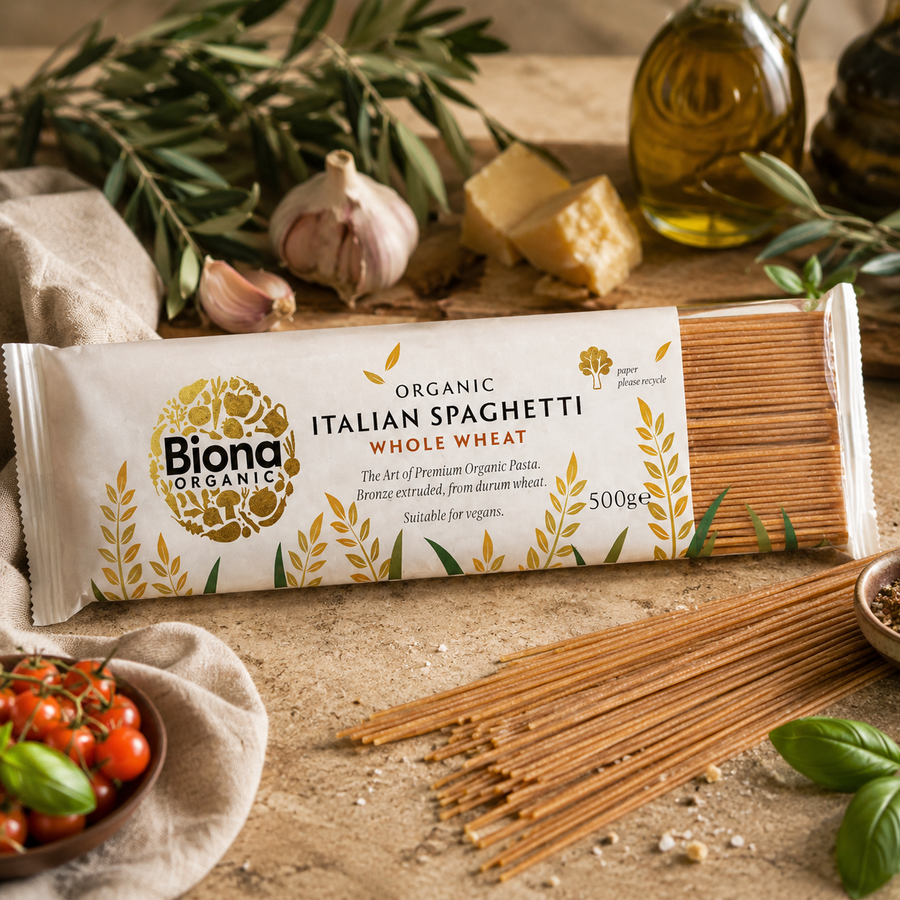 Biona Organic Italian Spaghetti Whole Wheat package on a rustic wooden table with fresh ingredients.