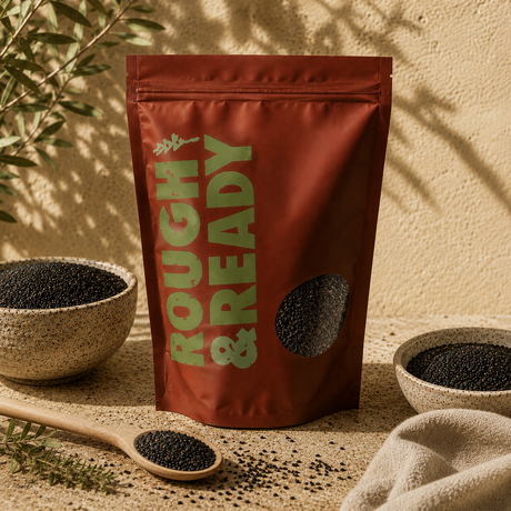 Red bag labeled 'Rough & Ready' with black seeds on a beige surface.