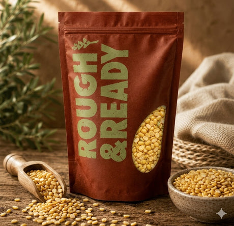 Bag of yellow seeds labeled 'Rough & Ready' on a wooden surface with seeds scattered around.