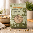 Infinity Foods Organic Muesli Base package on a wooden surface with a bowl of muesli in the background.