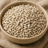 Bowl of rice grains on a textured fabric background