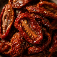 Close-up of dried tomatoes with a dark background