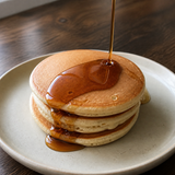 Biona organic dark agave syrup poured over pancakes