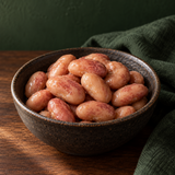 Cooked organic borlotti beans in a dark ceramic bowl
