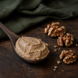 Spoonful of organic raw walnut butter with walnut halves