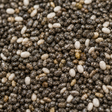 Close-up of chia seeds with a mix of black, white, and brown colors.