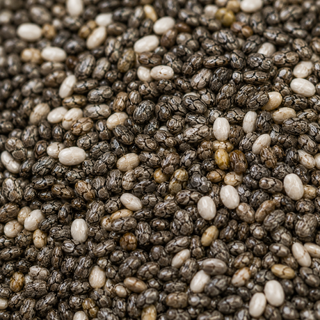 Close-up of chia seeds with a mix of black, white, and brown colors.