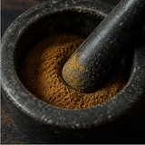 Organic ground cumin in mortar and pestle