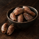 Organic Deglet Nour pitted dates in a serving bowl