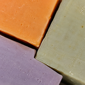 Extreme close-up of orange aloe vera and lavender soap bars