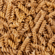 Extreme close-up of dry organic brown rice fusilli