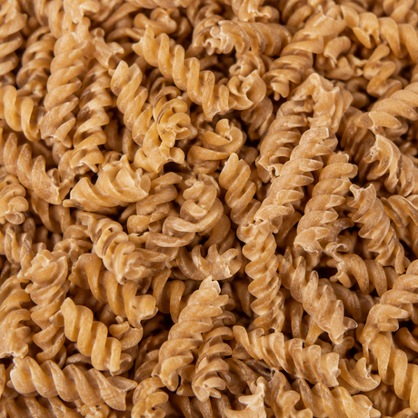 Extreme close-up of dry organic brown rice fusilli