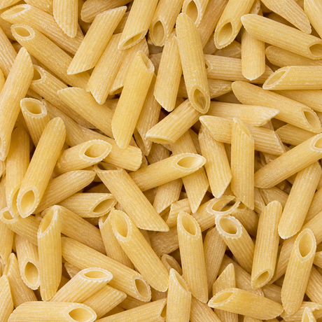 Extreme close-up of dry organic maize and rice penne