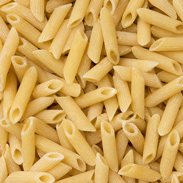 Extreme close-up of dry organic maize and rice penne