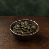 Austrian pumpkin seeds in a small dark bowl