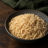 Cooked organic brown basmati rice served in a dark ceramic bowl