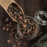 Organic chopped apricots pouring into a pantry jar
