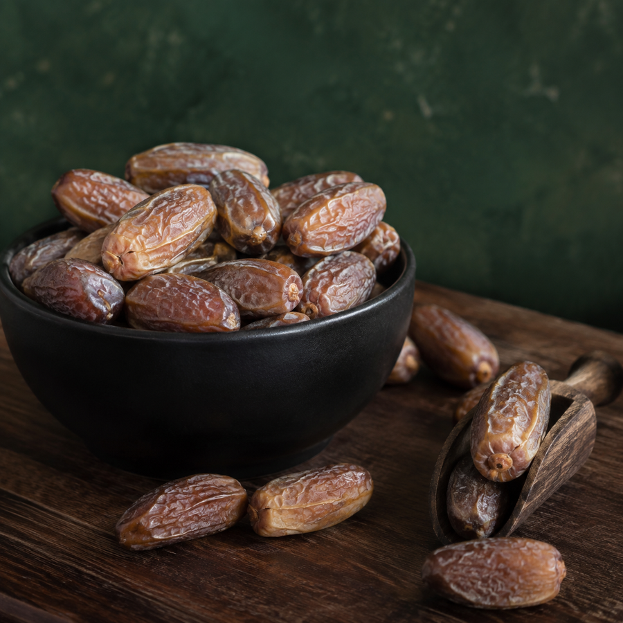 Organic Deglet Nour pitted dates in a black bowl