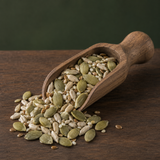 Organic Omega Four Seed Mix in a wooden scoop