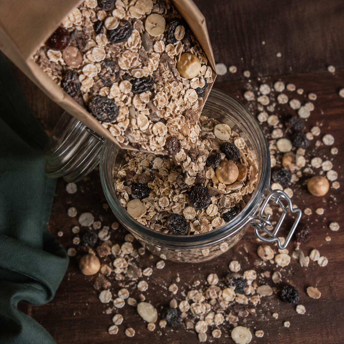 Organic super muesli pouring into a pantry jar