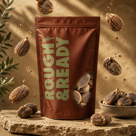Bag of 'Rough & Ready' with roasted chestnuts on a wooden surface with chestnuts scattered around.