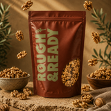 Brown 'Rough & Ready' bag with walnuts on a wooden surface with bowls and scattered walnuts.