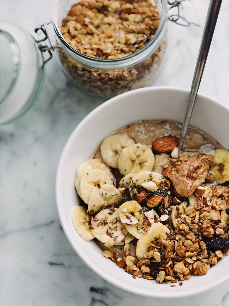 Breakfast bowl featuring granola, banana, nuts and seeds