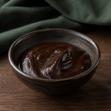 Organic hoisin sauce in a dark ceramic bowl