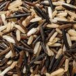 Close-up of mixed wild rice with black, brown, and white grains.